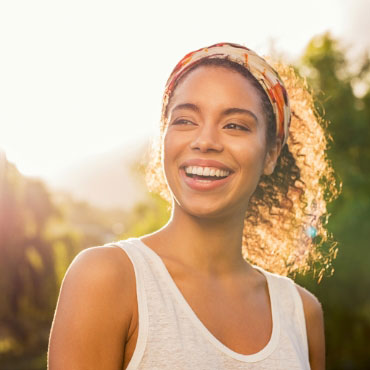 Smiling young female during a sunset